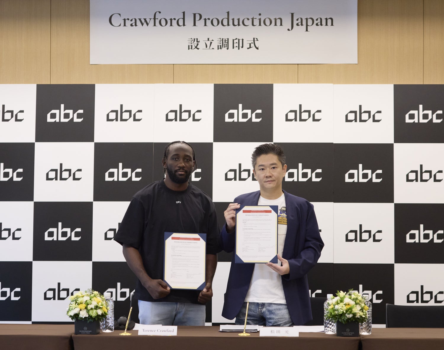 Terence Crawford and Gen Matsuda holding signed memoranda of understanding at the Crawford Production Japan signing ceremony in Tokyo